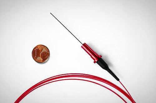 Miniaturized fiber-optic probe compared to one-cent coin